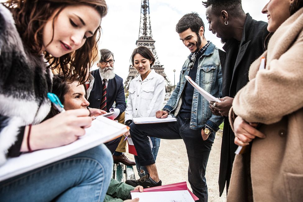 Students writing beside the Eiffel Tower in Paris