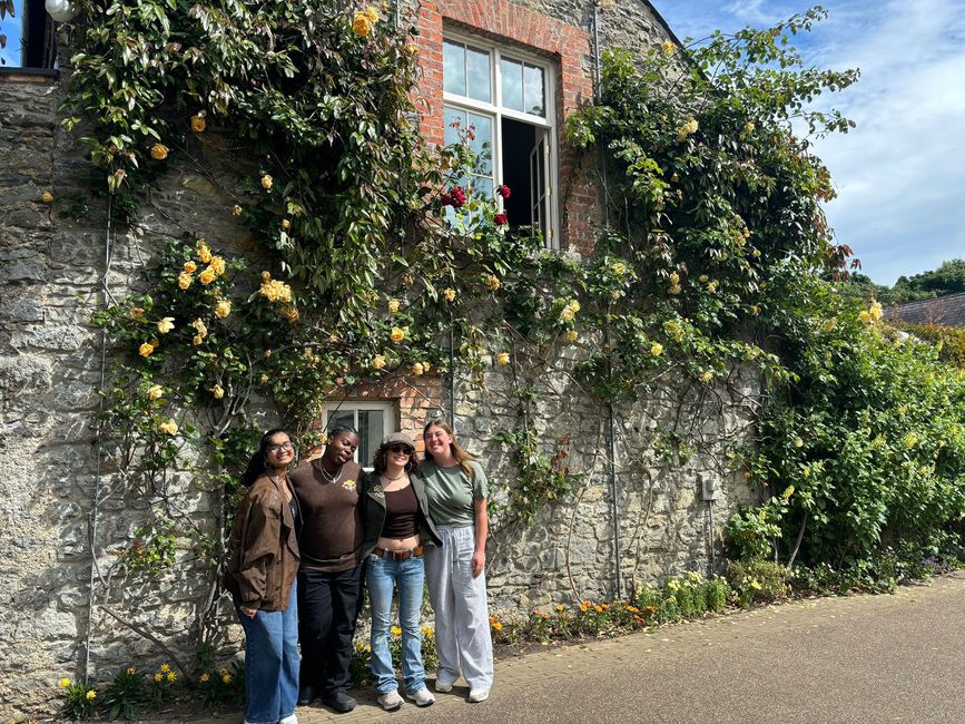 High schoolers posing by vine-covered house in Europe