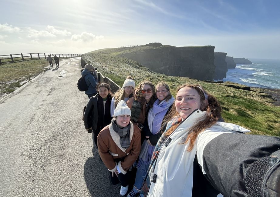 Group of teachers taking a group selfie by cliffs in Ireland