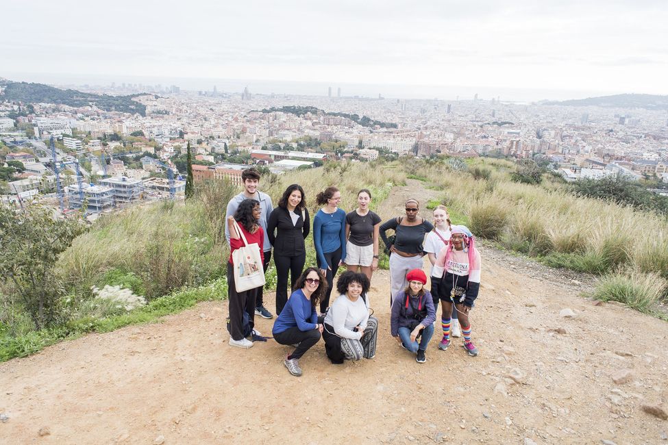 Group shot of students after a hike overlooking a city