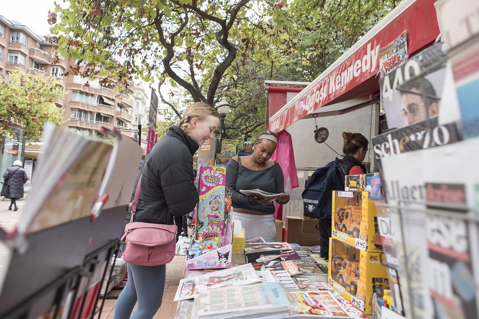 Students browsing market in a European city