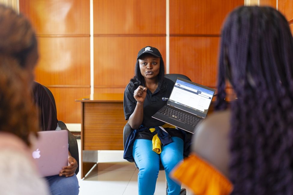 a student presenting to a group of students on a laptop