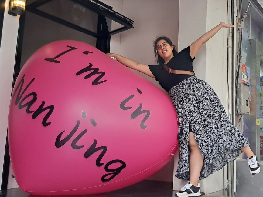 a person standing next to a heart