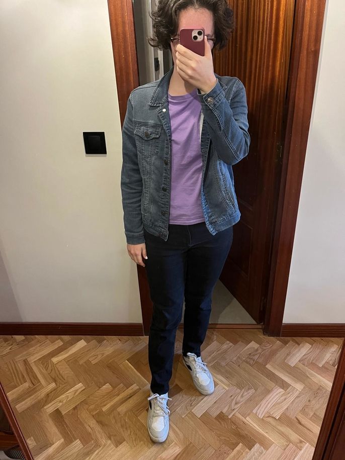 Purple shirt, jean jacket, and black jeans