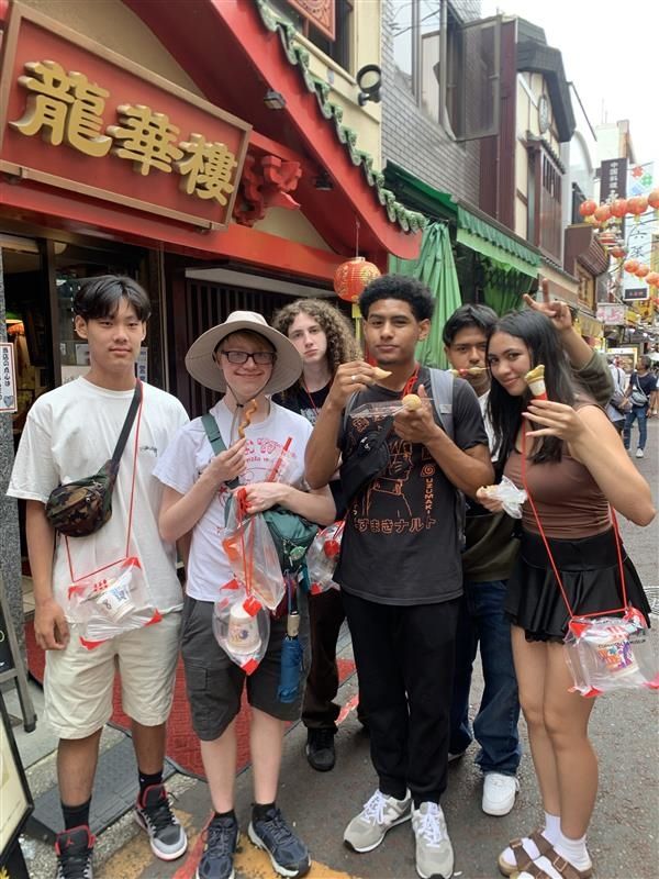 Group 3 students enjoying street foods in Yokohama Chinatown