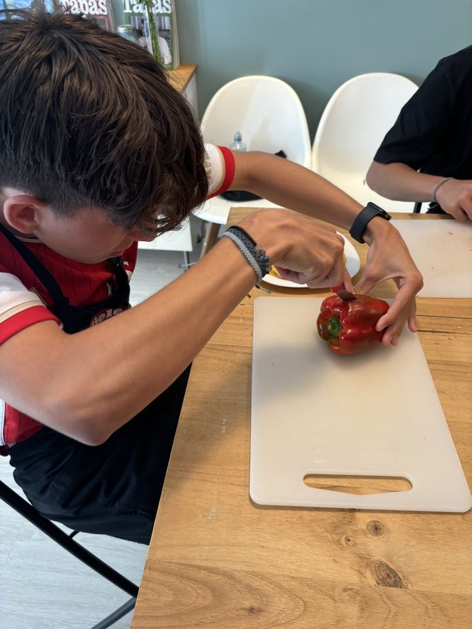 Student demonstrates new technique for cutting a pepper 