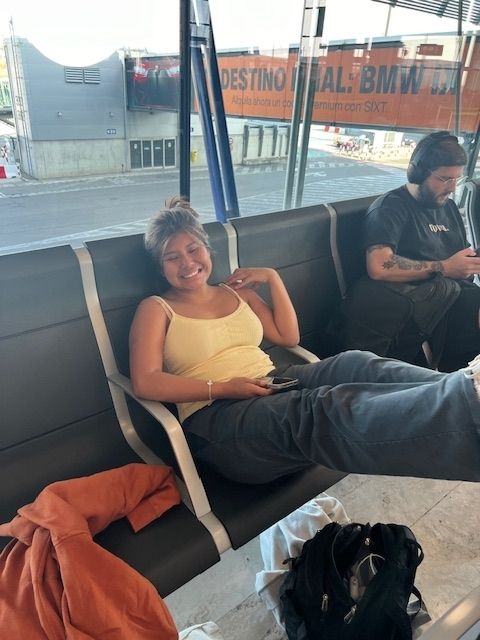 Student relaxing in Madrid airport waiting for flight to Alicante. 