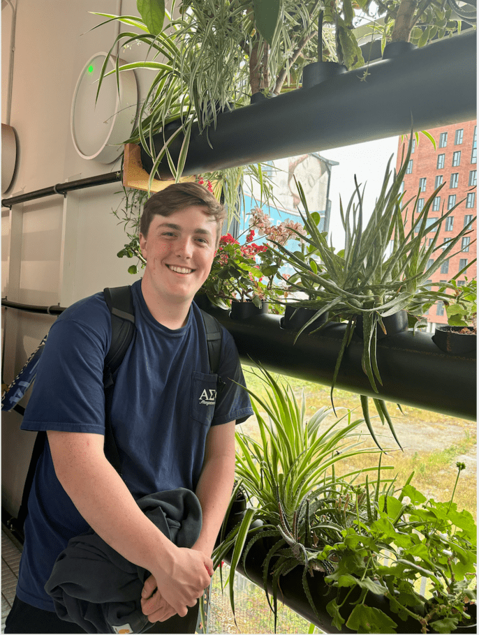 Student, Sean, learning about urban gardening