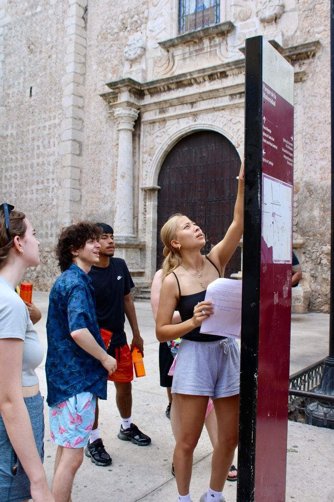 A group of students find the iconic church in the plaza.