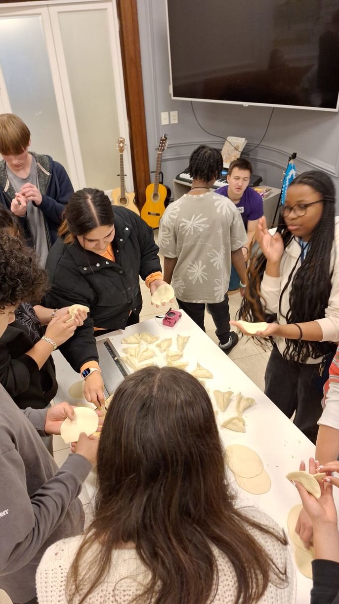 Students cut out and form pieces of dough.