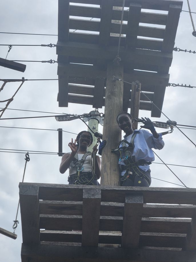 Anthonise and Shaiyanna pose in a photo on the rope course at the Legon Botanical Garden