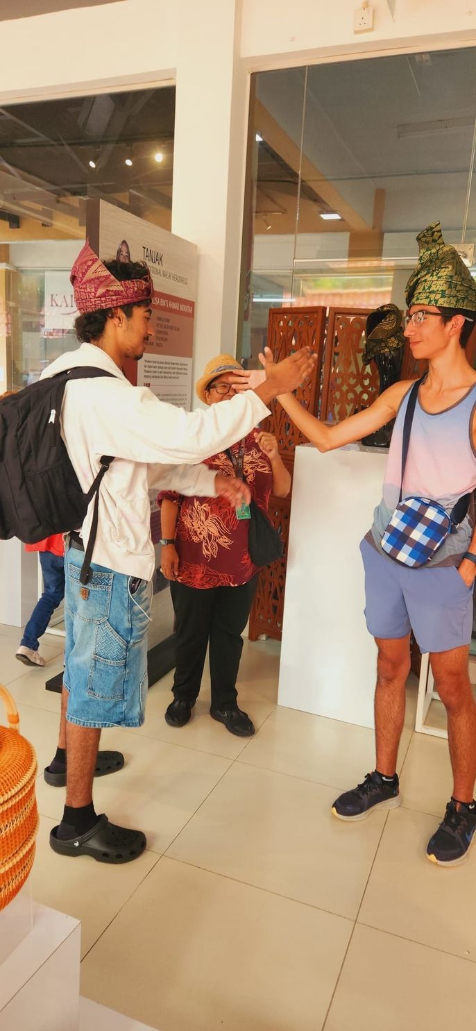 Students try traditional Malay clothes.