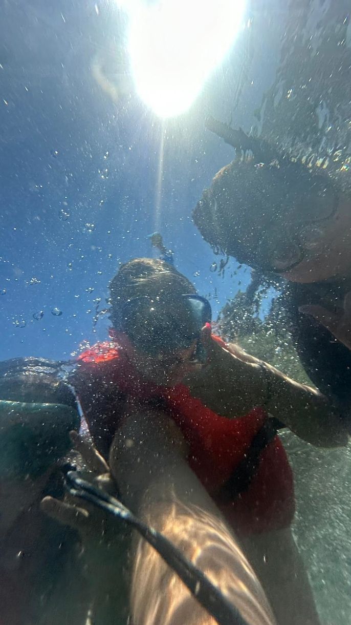 Selfie of three students snorkeling taken underwater