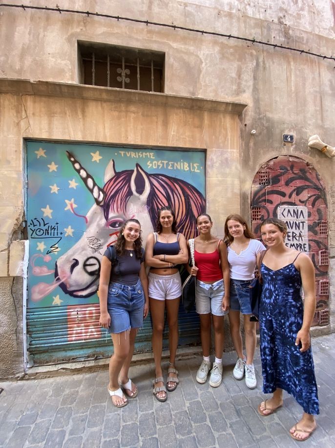 LC students in front of SOMA mural