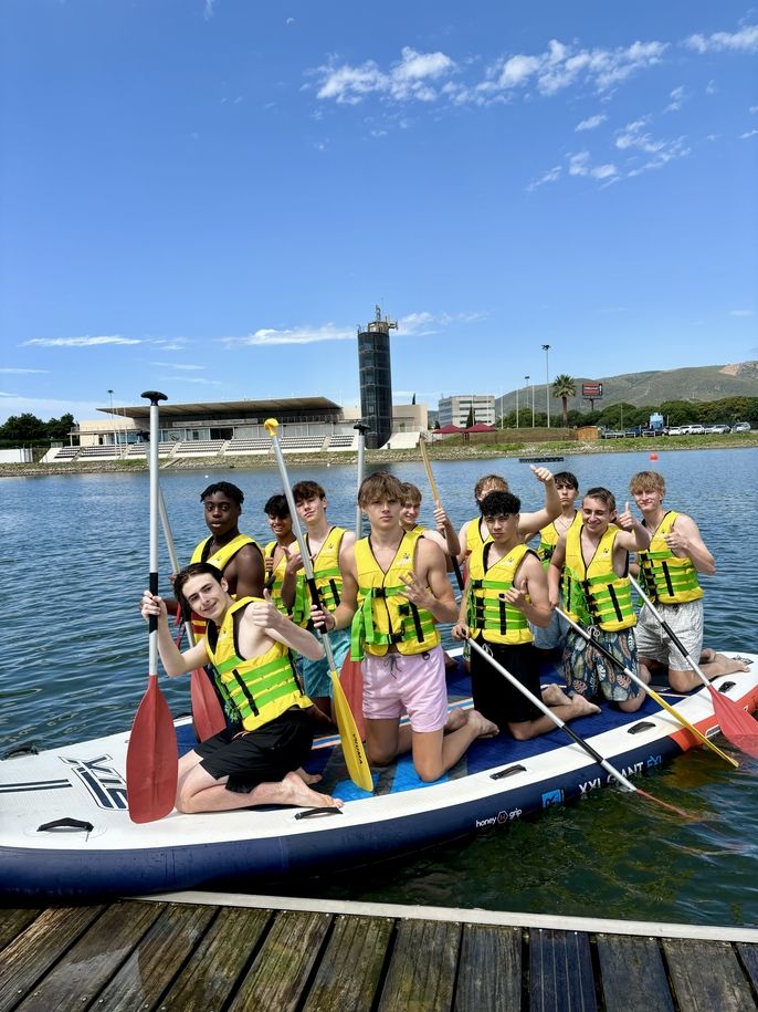 Students on their giant paddle board