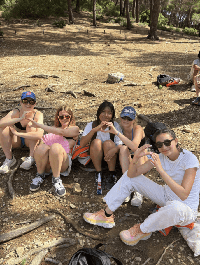 Students relax in the shade of a trail