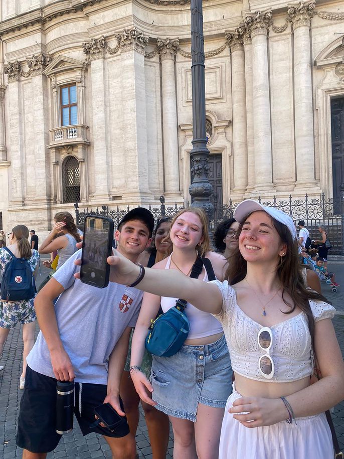 Students at Piazza Navona taking a group selfie