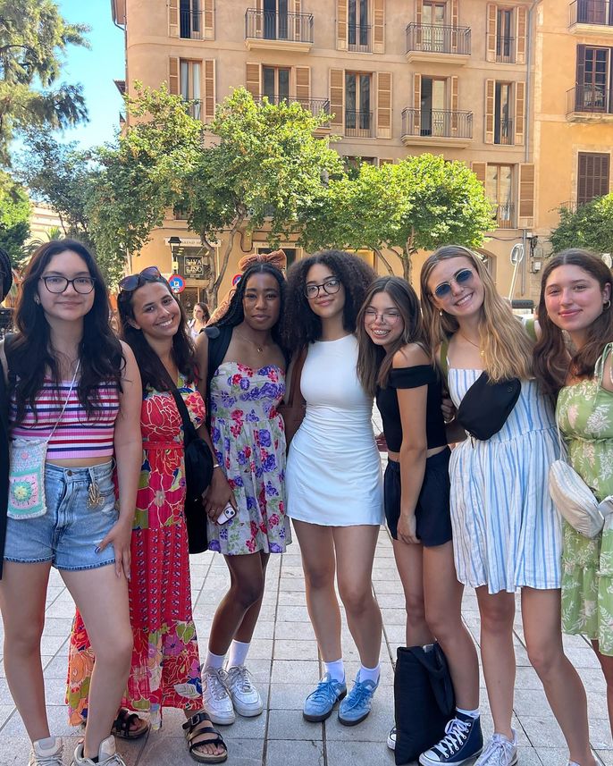 High school students posing on the street of a city in Europe