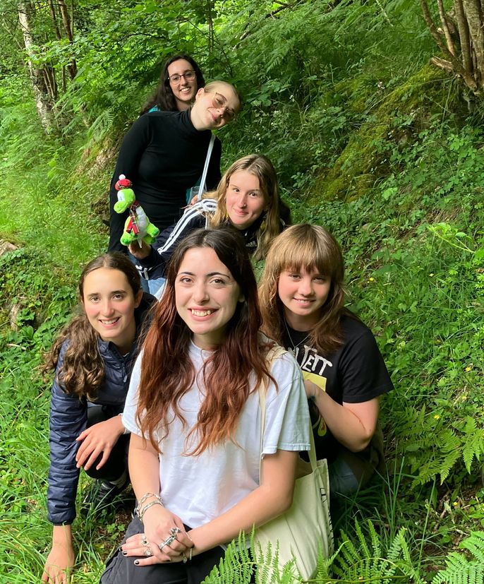 Students posing in a forest