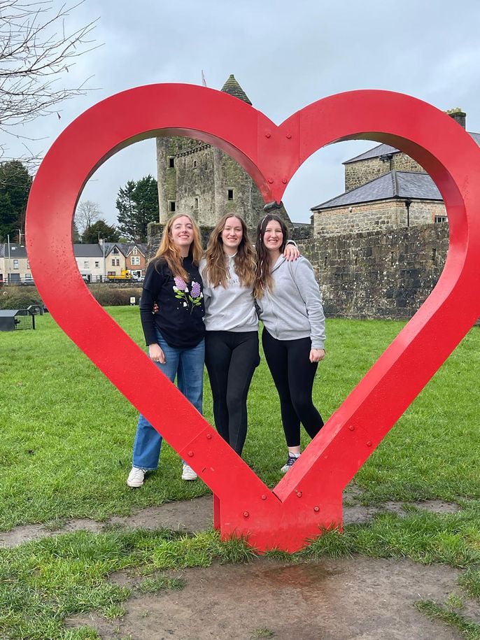 Group photo with heart sculpture at Enniskillen Castle in Ireland