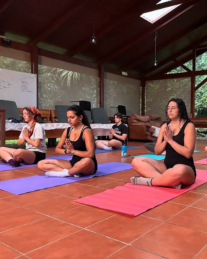 Teenagers doing yoga while studying abroad