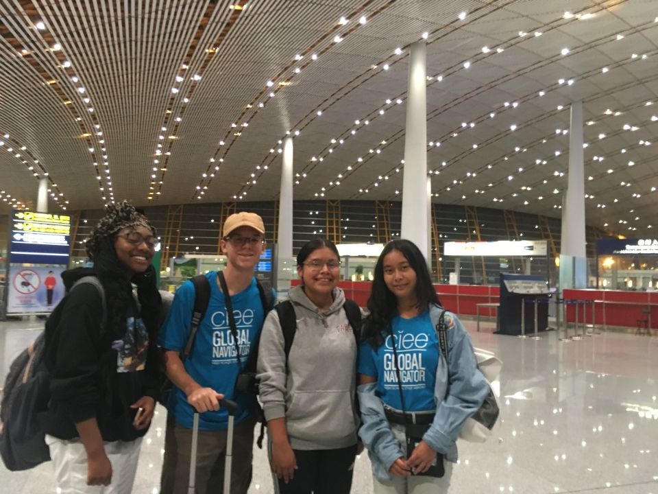 The students pose in the airport before heading to customs.