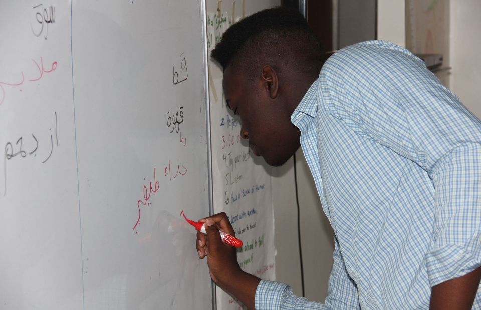 arabic language class student whiteboard writing