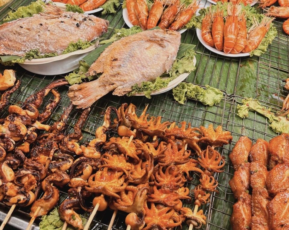 Thai street food- mini octopi and squid on sticks with raw fish and shrimp.