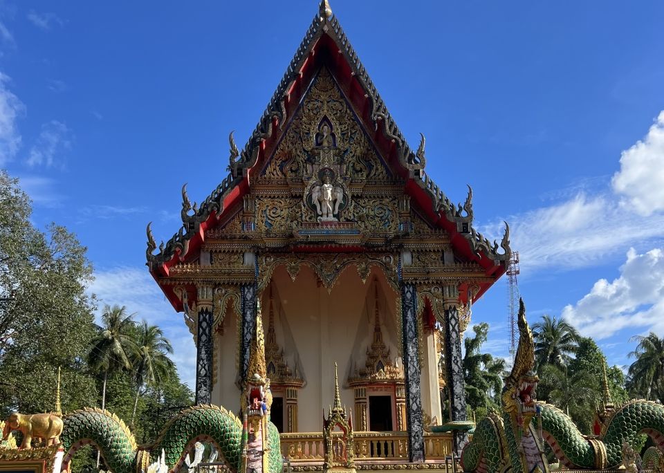 A colorful temple with naga flanking the staircase. 