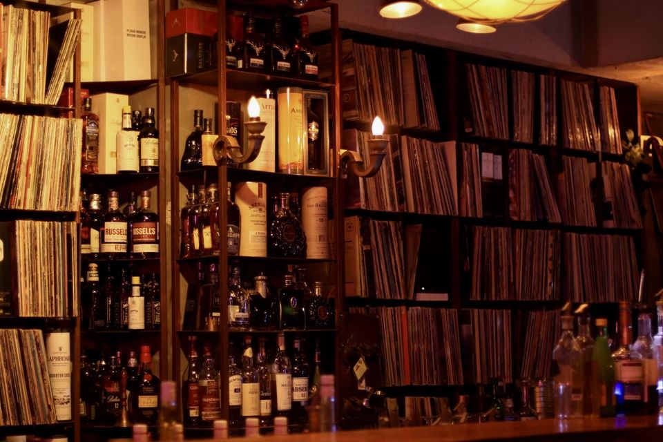 Vinyl and liquor bottle packed shelves