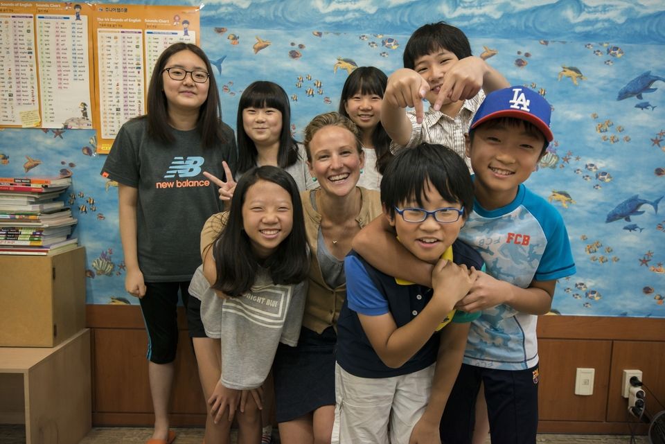 American teacher in south korea smiling with a group of students