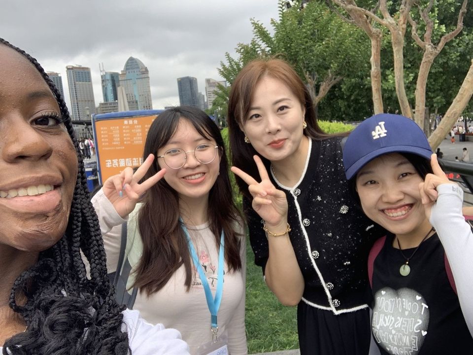 Two CIEE high school students pose with two women on the Bund. 