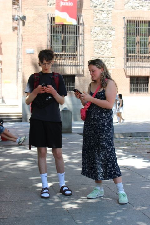 Two students using their phones