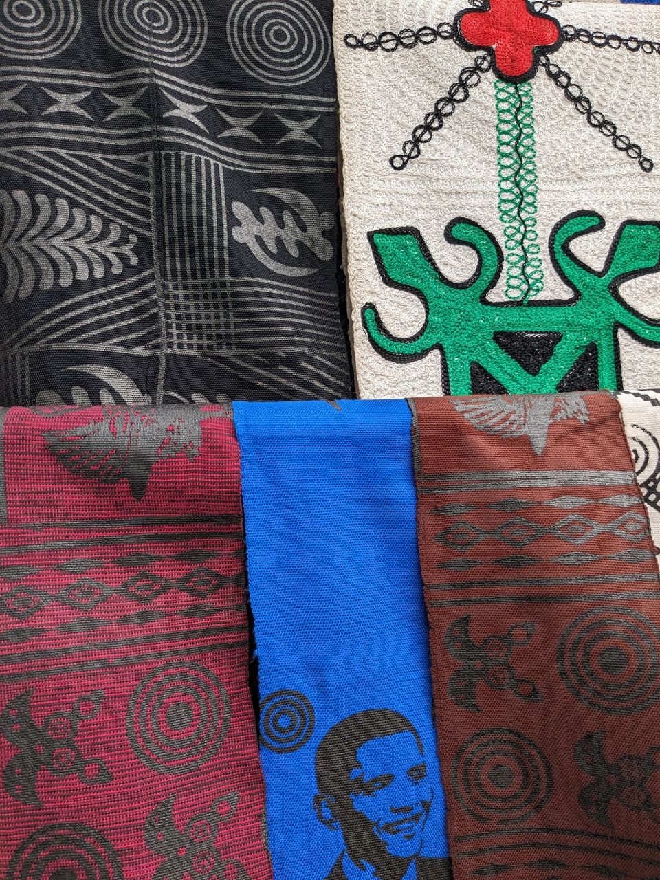 Strips of woven fabric with Adinkra embroidery or dye stamped on them. Innovations also include stamps of prominent figures in various societies.