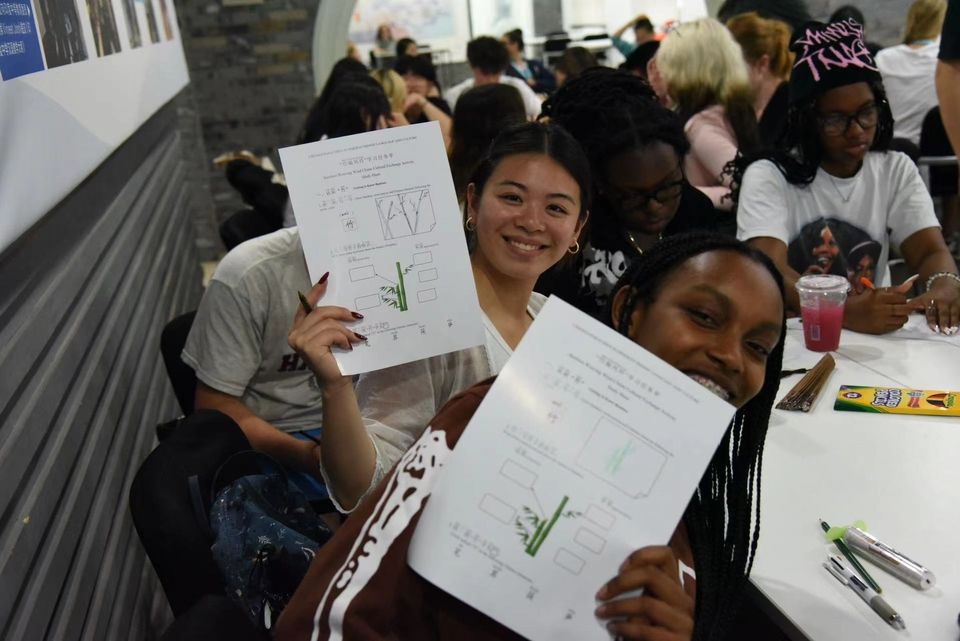 Holding up bamboo chime worksheets! Ready to start crafting