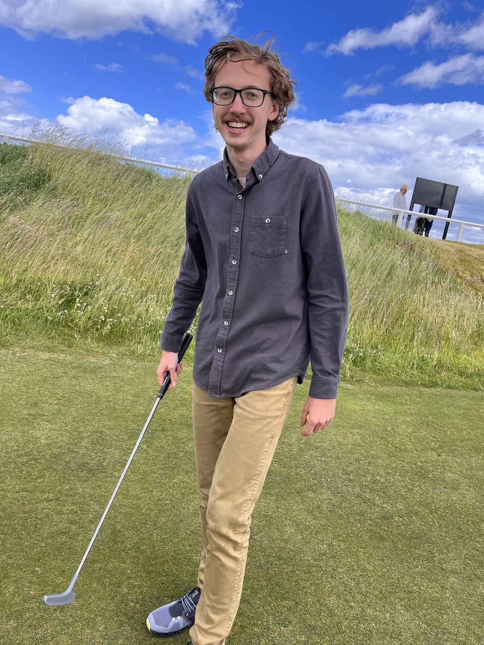 Student with golf club playing at St Andrews Golf Course