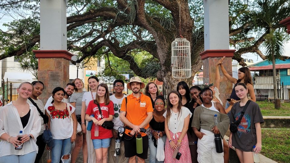 Students pose at the conclusion of the mural tours with the tour guide.