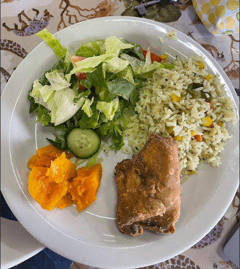 Dinner with rice, chicken, salad and sweet potatoes.