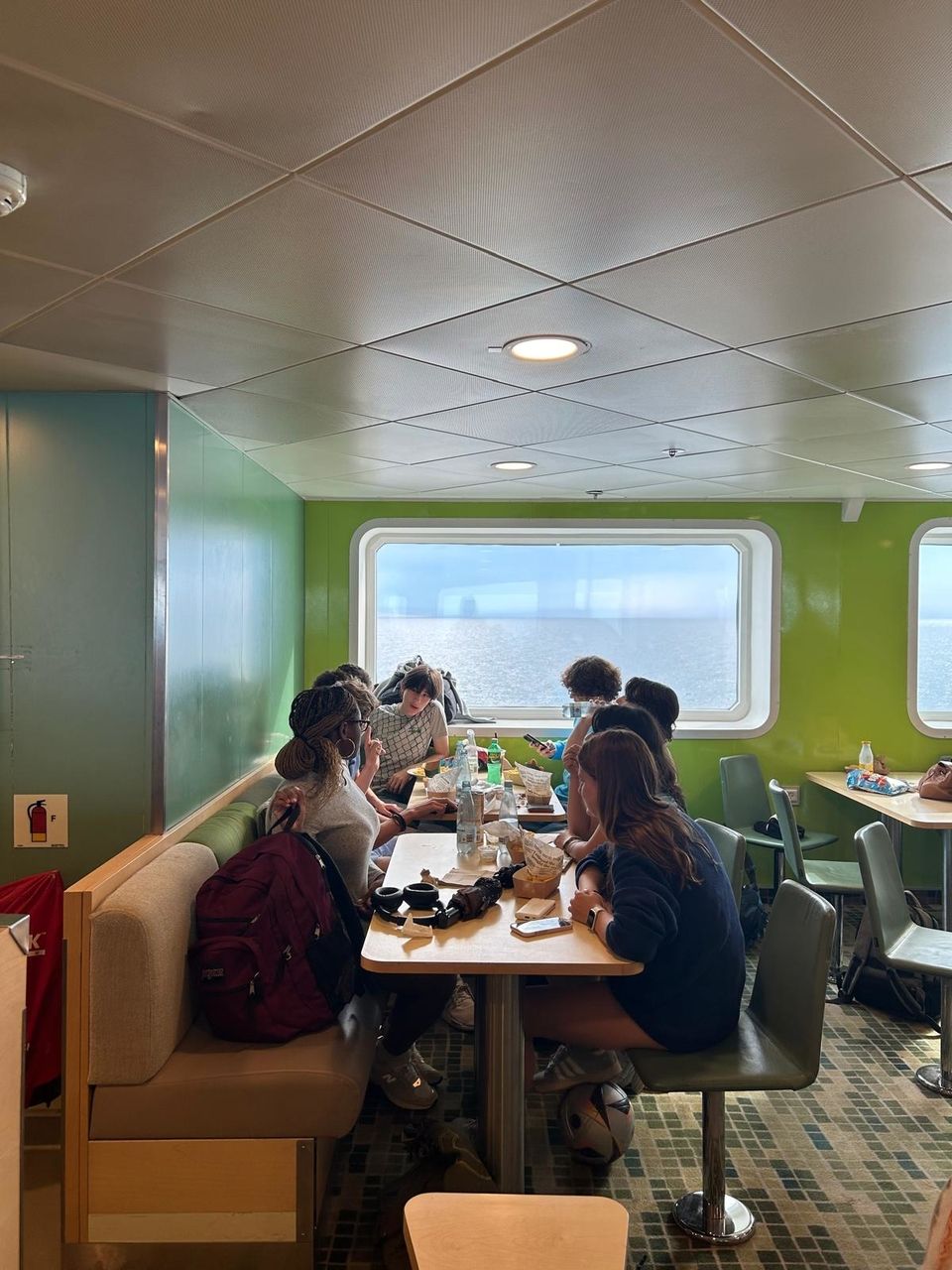 Students enjoying food and conversation on the ferry.