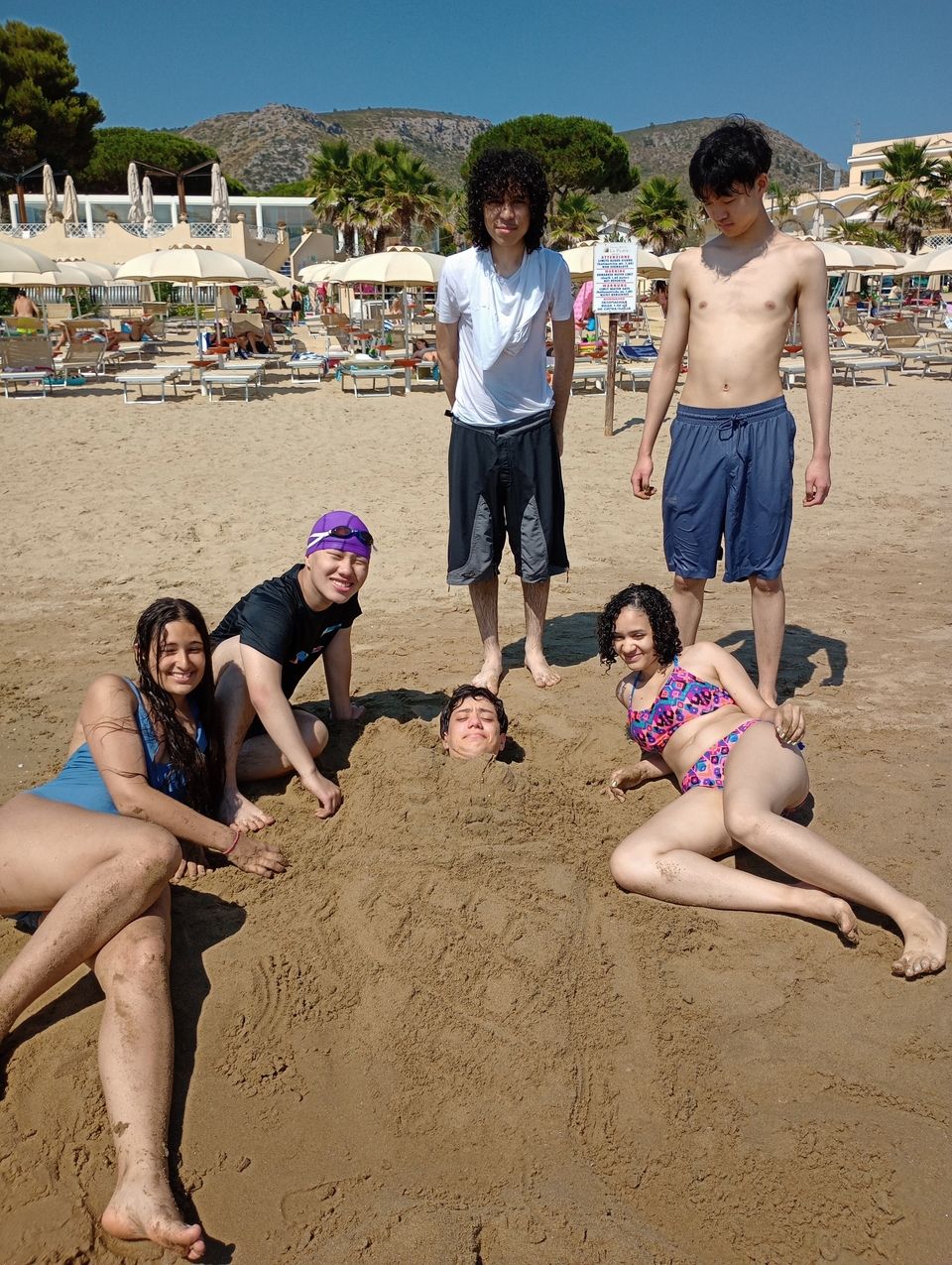 Students transforming their fellow navigator into a sand merman.