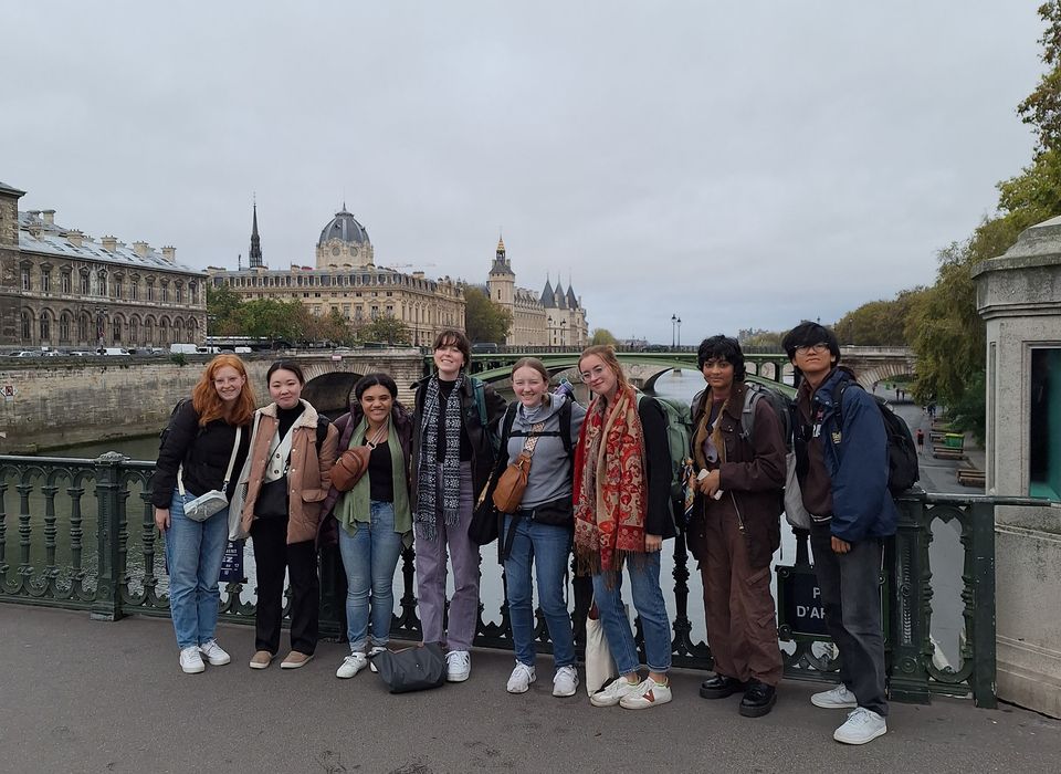 Gap students posting by the Seine River in Paris