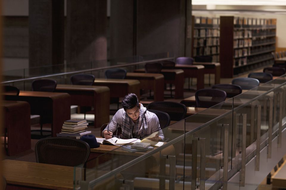 Student studying in library at night