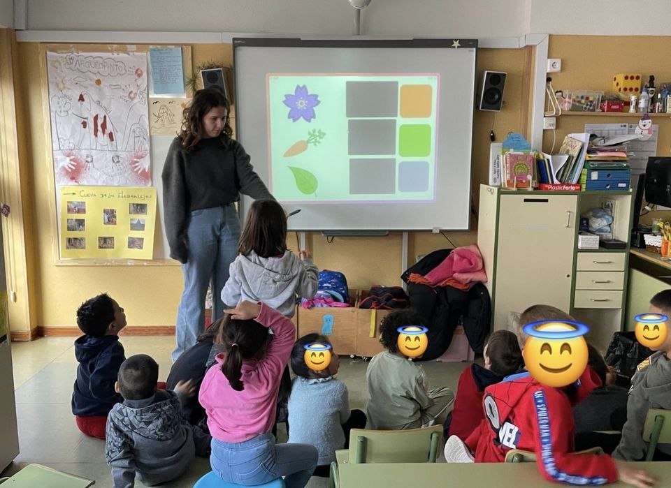 group of students looking at a whiteboard and playing a color matching game